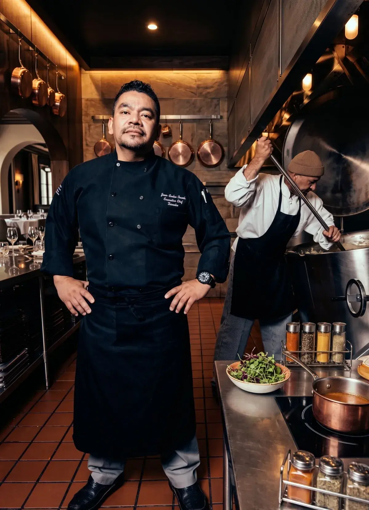Chef Juan Carlos Penate in chef's coat, in a professional kitchen setting